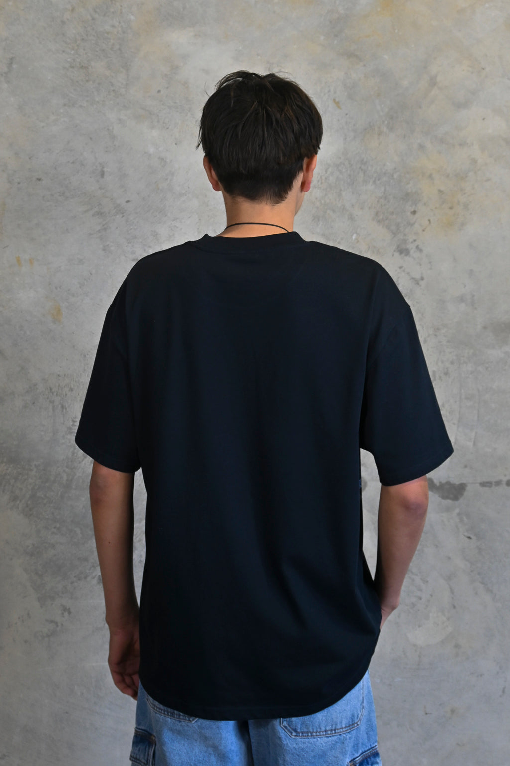 Back view of oversized heavy cotton t-shirt in deep midnight navy