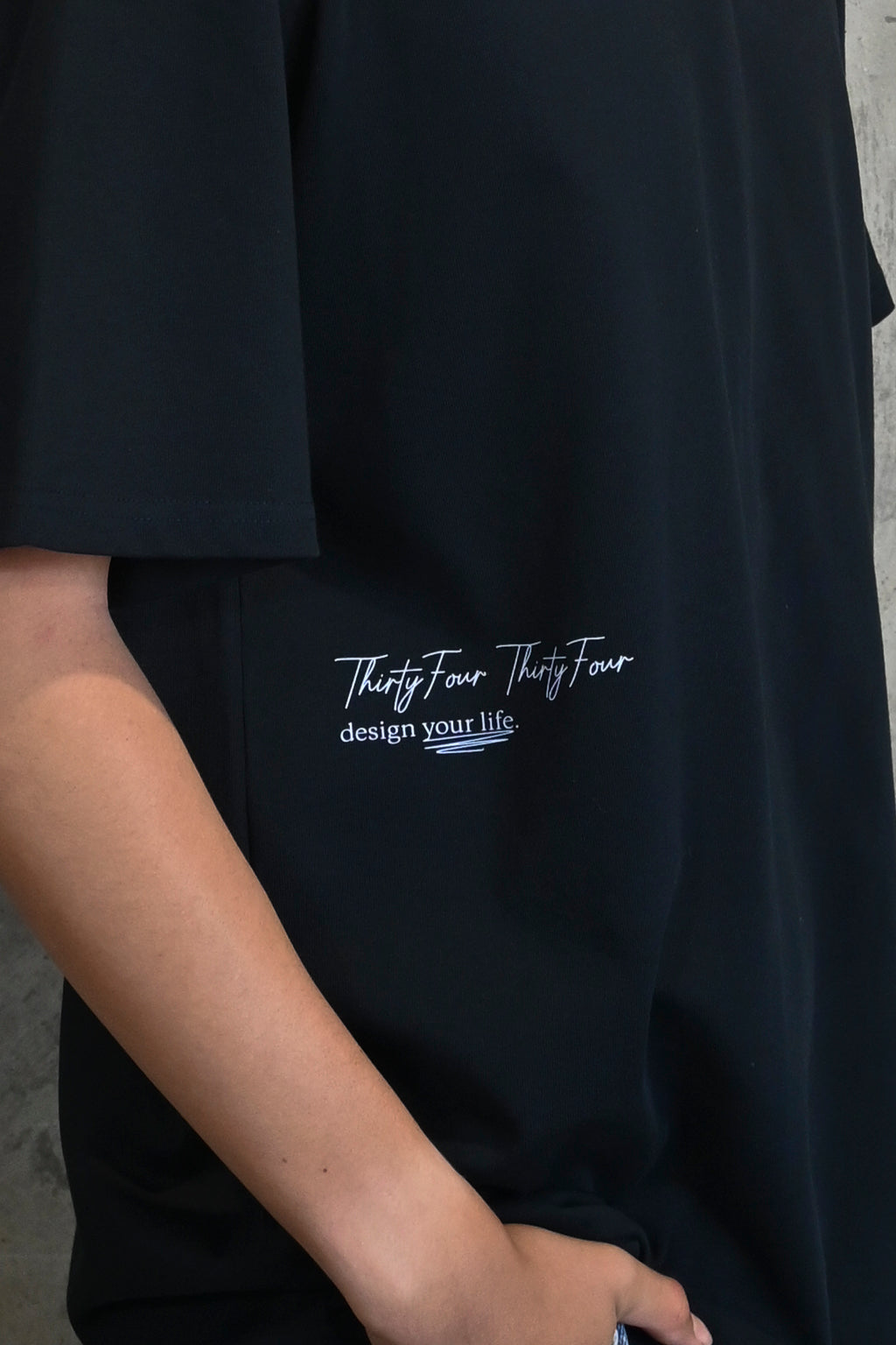 Close-up of Thirty Four Thirty Four logo and text design your life in light blue print