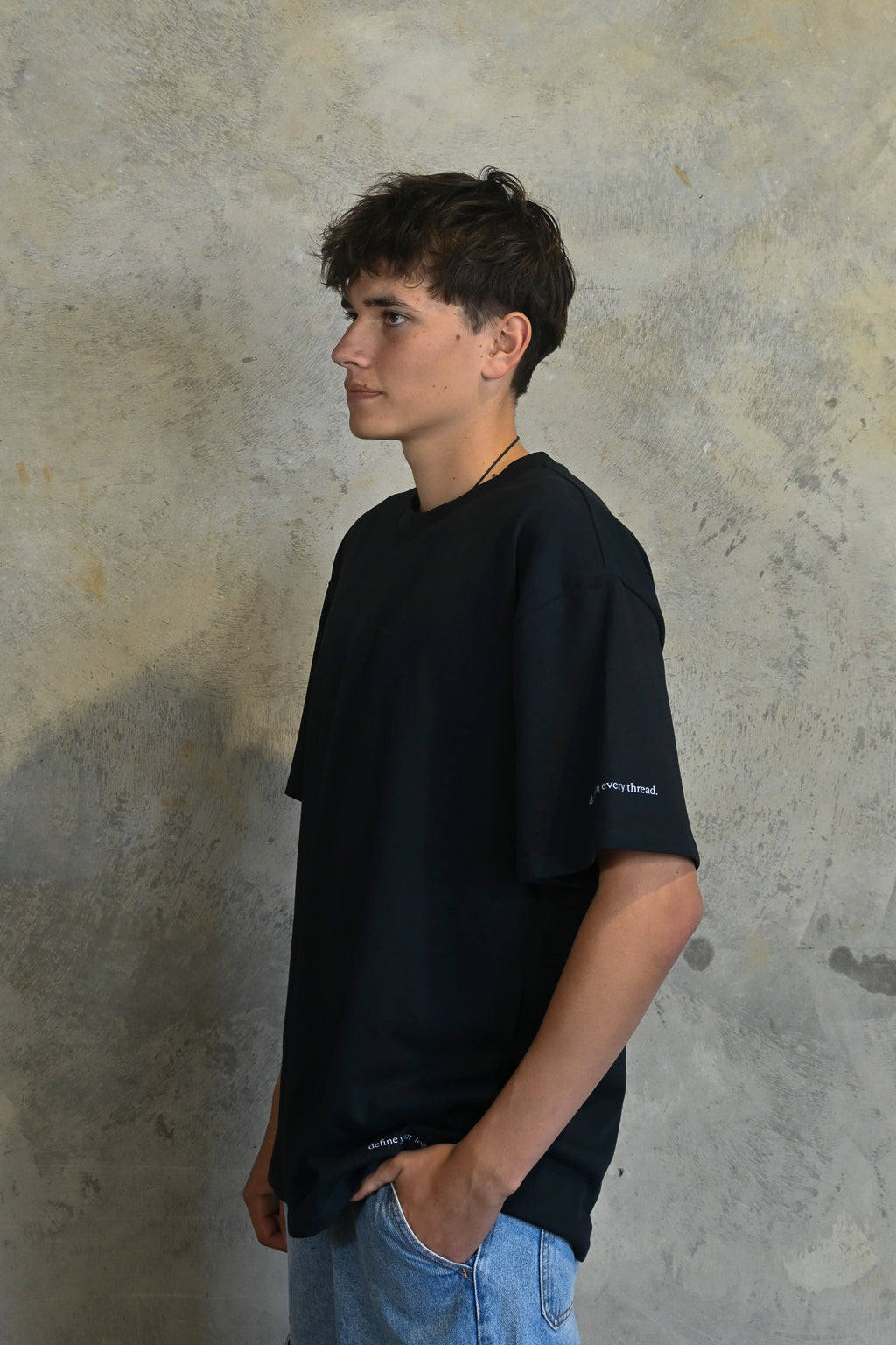 Detail of define your legacy print on lower front of Midnight Oversized Heavy Tee