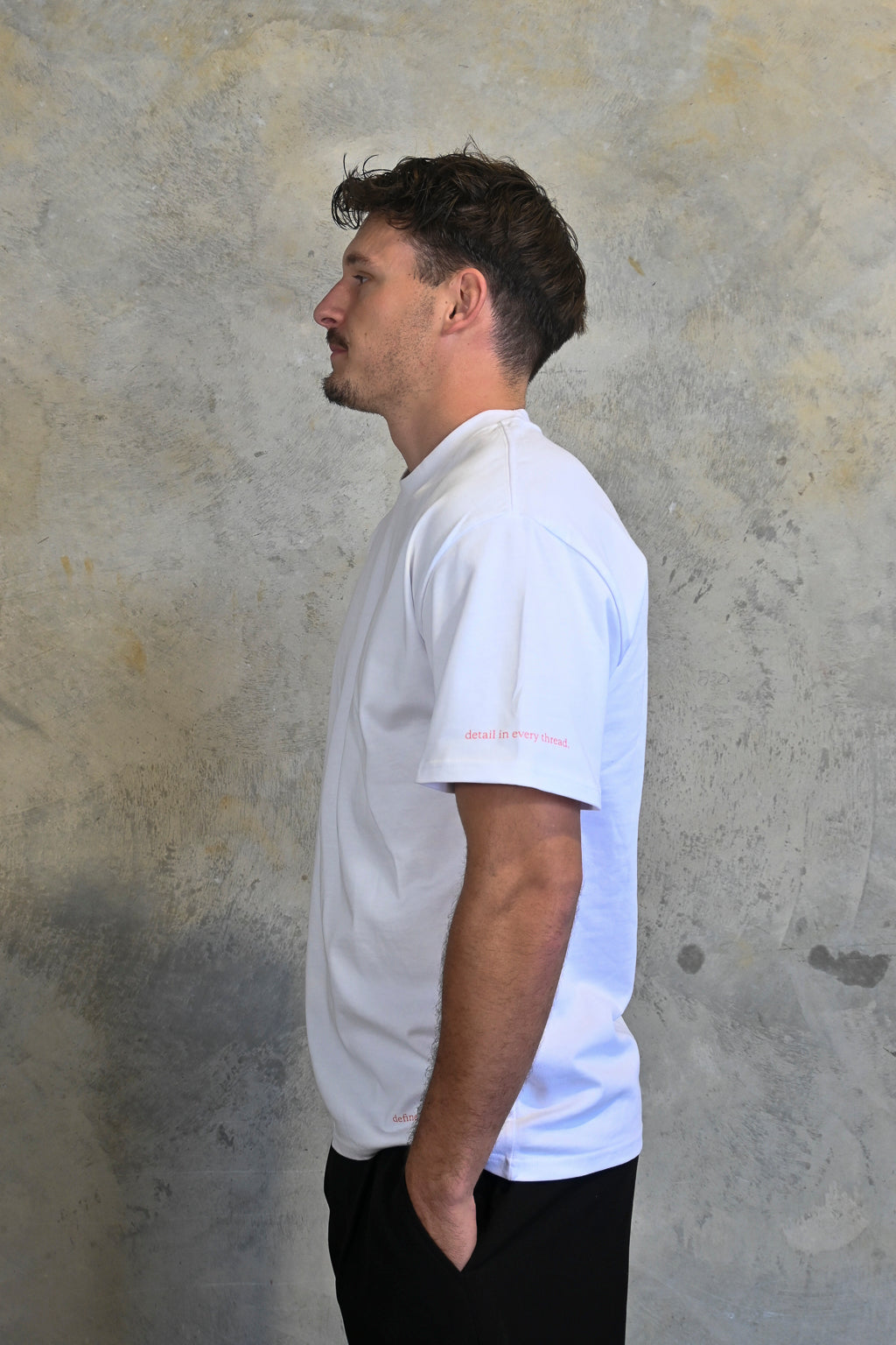 Male model styling minimalist white and red oversized streetwear tee