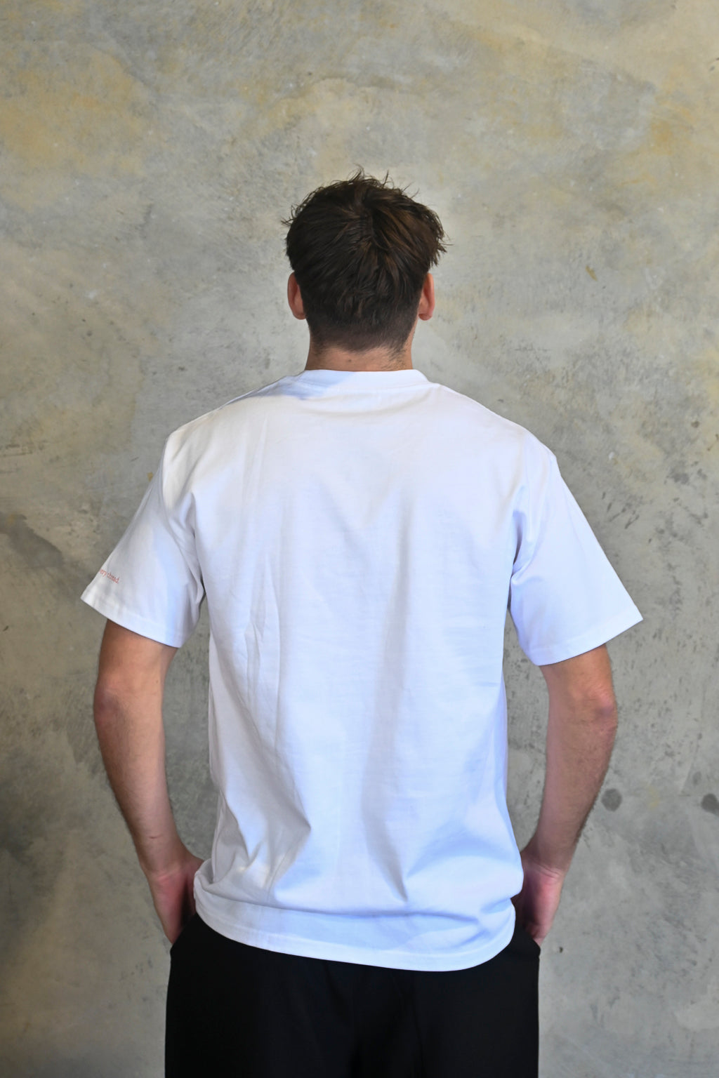 Back view of white oversized streetwear tee in premium heavyweight cotton